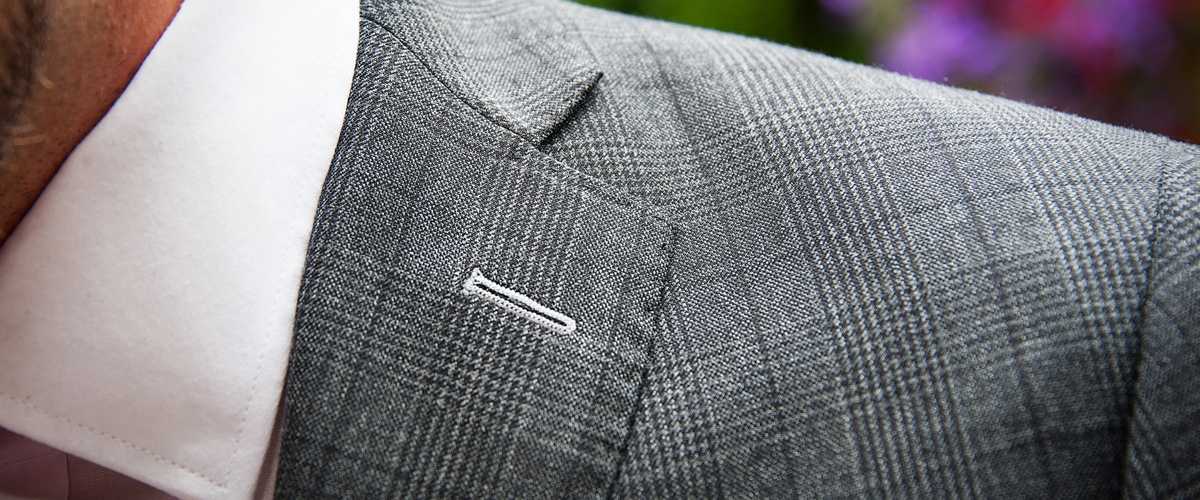 Tailored Prince of Wales grey check suit lapel detail